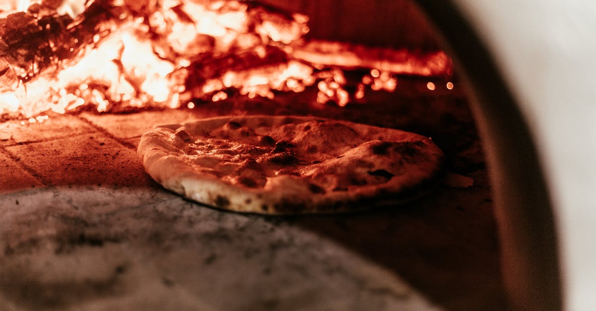 close up of a pizza baking in a traditional wood fired oven